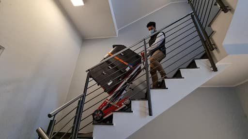 Transporting a photocopier on stairs with a hand cart for stairs 