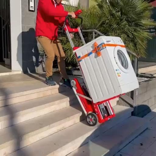 Transporting a washing machine up the stairs with a stair climbing dolly